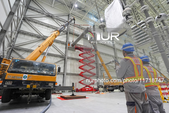 Power maintenance personnel overhaul the equipment of Guquan converter station in Xuancheng, China, on October 29, 2024. 