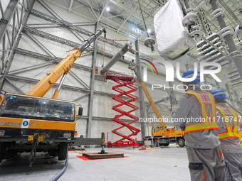 Power maintenance personnel overhaul the equipment of Guquan converter station in Xuancheng, China, on October 29, 2024. (