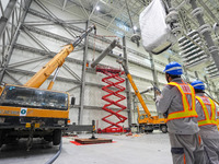 Power maintenance personnel overhaul the equipment of Guquan converter station in Xuancheng, China, on October 29, 2024. (