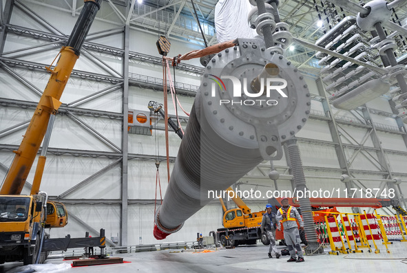 Power maintenance personnel overhaul the equipment of Guquan converter station in Xuancheng, China, on October 29, 2024. 