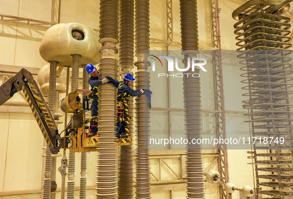 Power maintenance personnel overhaul the equipment of Guquan converter station in Xuancheng, China, on October 29, 2024. 