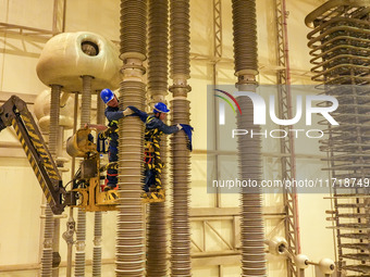 Power maintenance personnel overhaul the equipment of Guquan converter station in Xuancheng, China, on October 29, 2024. (