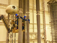 Power maintenance personnel overhaul the equipment of Guquan converter station in Xuancheng, China, on October 29, 2024. (