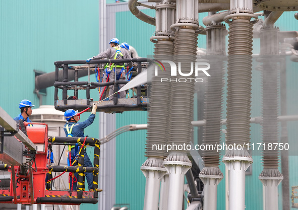 Power maintenance personnel overhaul the equipment of Guquan converter station in Xuancheng, China, on October 29, 2024. 