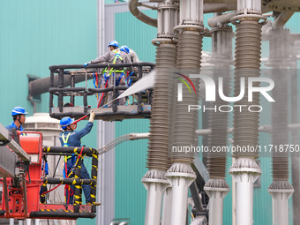 Power maintenance personnel overhaul the equipment of Guquan converter station in Xuancheng, China, on October 29, 2024. (