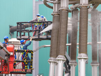 Power maintenance personnel overhaul the equipment of Guquan converter station in Xuancheng, China, on October 29, 2024. (