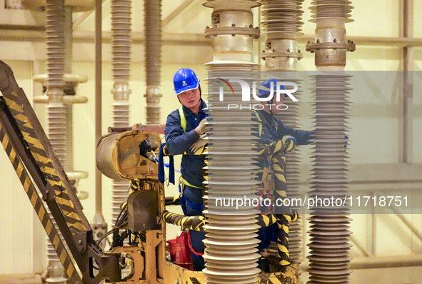 Power maintenance personnel overhaul the equipment of Guquan converter station in Xuancheng, China, on October 29, 2024. 