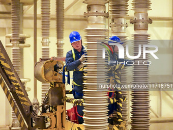 Power maintenance personnel overhaul the equipment of Guquan converter station in Xuancheng, China, on October 29, 2024. (