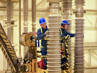 Power maintenance personnel overhaul the equipment of Guquan converter station in Xuancheng, China, on October 29, 2024. (