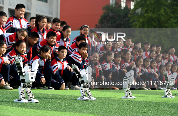 Primary school students watch a dancing robot performance in Handan, China, on October 29, 2024. 