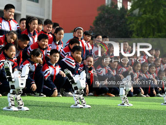 Primary school students watch a dancing robot performance in Handan, China, on October 29, 2024. (