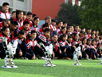 Primary school students watch a dancing robot performance in Handan, China, on October 29, 2024. (