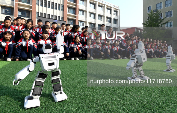 Primary school students watch a dancing robot performance in Handan, China, on October 29, 2024. 