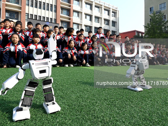 Primary school students watch a dancing robot performance in Handan, China, on October 29, 2024. (