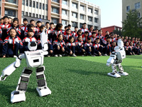 Primary school students watch a dancing robot performance in Handan, China, on October 29, 2024. (