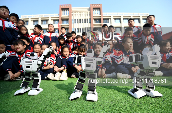 Primary school students watch a dancing robot performance in Handan, China, on October 29, 2024. 