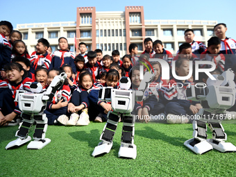 Primary school students watch a dancing robot performance in Handan, China, on October 29, 2024. (