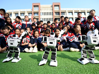 Primary school students watch a dancing robot performance in Handan, China, on October 29, 2024. (