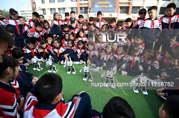 Primary school students watch a dancing robot performance in Handan, China, on October 29, 2024. 