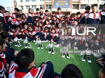 Primary school students watch a dancing robot performance in Handan, China, on October 29, 2024. (