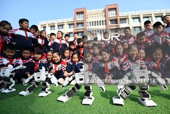 Primary school students watch a dancing robot performance in Handan, China, on October 29, 2024. 