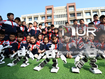 Primary school students watch a dancing robot performance in Handan, China, on October 29, 2024. (