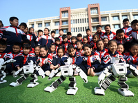 Primary school students watch a dancing robot performance in Handan, China, on October 29, 2024. (