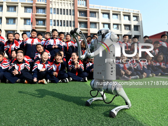 Primary school students interact with a robot dog in Handan, China, on October 29, 2024. (