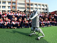 Primary school students interact with a robot dog in Handan, China, on October 29, 2024. (