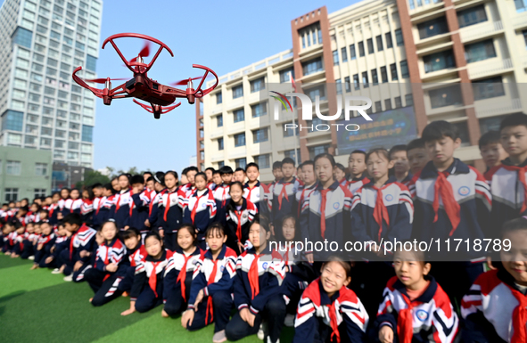 Primary school students watch a drone performance in Handan, China, on October 29, 2024. 