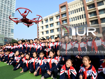 Primary school students watch a drone performance in Handan, China, on October 29, 2024. (