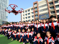 Primary school students watch a drone performance in Handan, China, on October 29, 2024. (