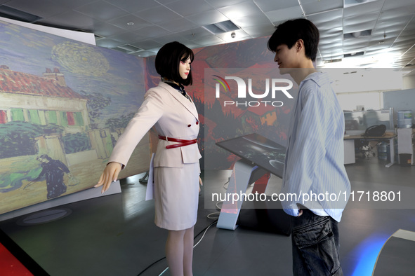 A citizen interacts with Tang Yu, a Netdragon AI robot, at the Netdragon Base of Digital Education Town in Changle District in Fuzhou, China...