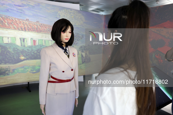 A citizen interacts with Tang Yu, a Netdragon AI robot, at the Netdragon Base of Digital Education Town in Changle District in Fuzhou, China...