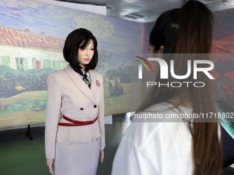 A citizen interacts with Tang Yu, a Netdragon AI robot, at the Netdragon Base of Digital Education Town in Changle District in Fuzhou, China...