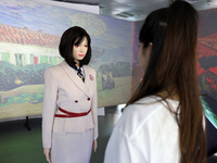 A citizen interacts with Tang Yu, a Netdragon AI robot, at the Netdragon Base of Digital Education Town in Changle District in Fuzhou, China...