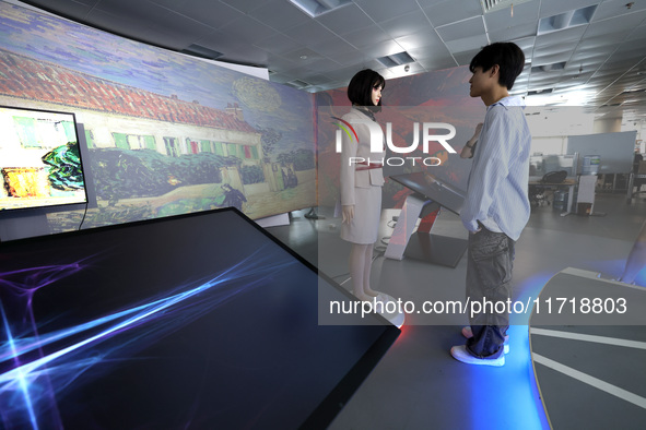 A citizen interacts with Tang Yu, a Netdragon AI robot, at the Netdragon Base of Digital Education Town in Changle District in Fuzhou, China...