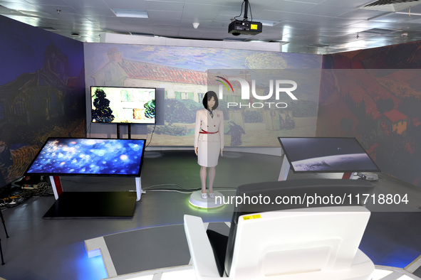 A citizen interacts with Tang Yu, a Netdragon AI robot, at the Netdragon Base of Digital Education Town in Changle District in Fuzhou, China...