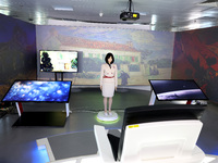 A citizen interacts with Tang Yu, a Netdragon AI robot, at the Netdragon Base of Digital Education Town in Changle District in Fuzhou, China...