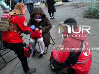 Paramedics help an elderly woman in the Solomianskyi district after a Russian drone attack in Kyiv, Ukraine, on October 29, 2024. Six people...