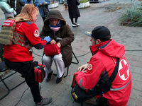 Paramedics help an elderly woman in the Solomianskyi district after a Russian drone attack in Kyiv, Ukraine, on October 29, 2024. Six people...