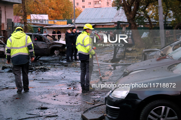 Law enforcers in high-visibility vests are at the scene in the Solomianskyi district after a Russian drone attack in Kyiv, Ukraine, on Octob...