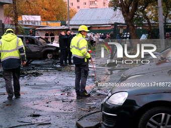 Law enforcers in high-visibility vests are at the scene in the Solomianskyi district after a Russian drone attack in Kyiv, Ukraine, on Octob...