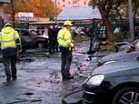 Law enforcers in high-visibility vests are at the scene in the Solomianskyi district after a Russian drone attack in Kyiv, Ukraine, on Octob...