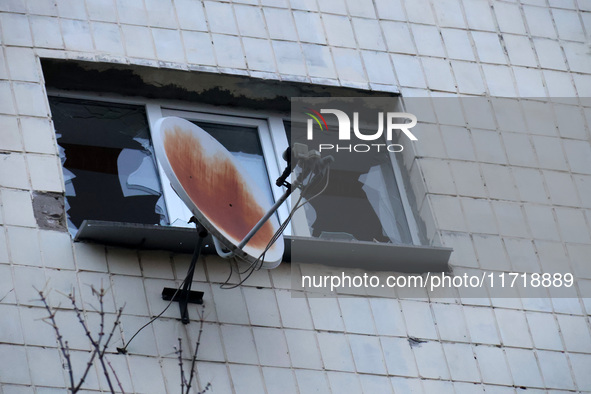 A satellite dish is next to a shattered window at an apartment block in the Solomianskyi district damaged by a Russian drone attack in Kyiv,...