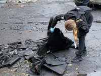 A police officer studies the fragments of a Russian UAV in the Solomianskyi district after a Russian drone attack in Kyiv, Ukraine, on Octob...