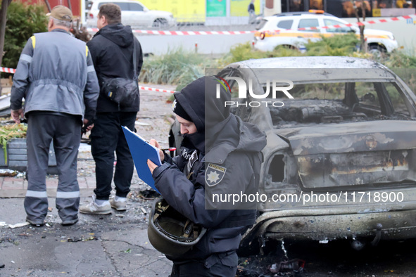 A police officer fills in the papers in the Solomianskyi district after a Russian drone attack in Kyiv, Ukraine, on October 29, 2024. Six pe...