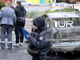 A police officer fills in the papers in the Solomianskyi district after a Russian drone attack in Kyiv, Ukraine, on October 29, 2024. Six pe...