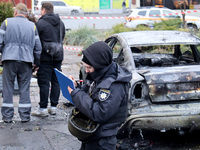 A police officer fills in the papers in the Solomianskyi district after a Russian drone attack in Kyiv, Ukraine, on October 29, 2024. Six pe...