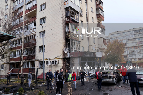 Onlookers stand outside an apartment block in the Solomianskyi district damaged by a Russian drone attack in Kyiv, Ukraine, on October 29, 2...